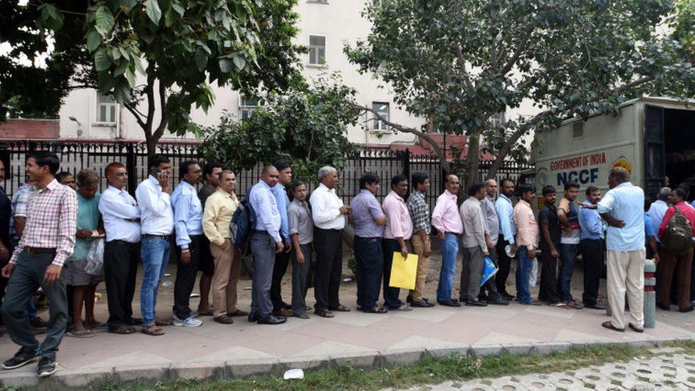 People stand in a queue to buy onions sold at Rs. 22 per kg by the Government of India, outside Krishi Bhawan on September 24, 2019 in New Delhi, India.