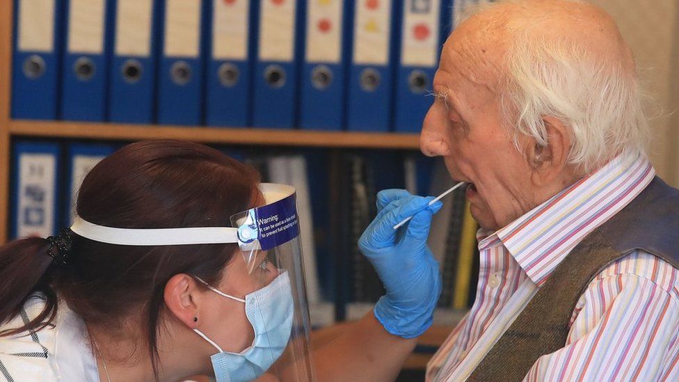 A care home resident is tested for coronavirus