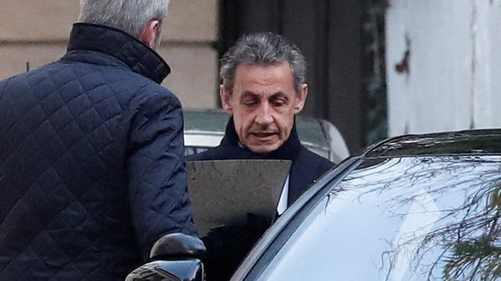 Former French President Nicolas Sarkozy enters his car as he leaves his house in Paris, 21 March 2018