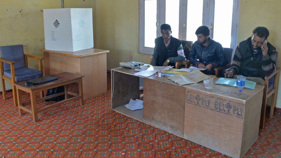 Polling officers inside an empty police station