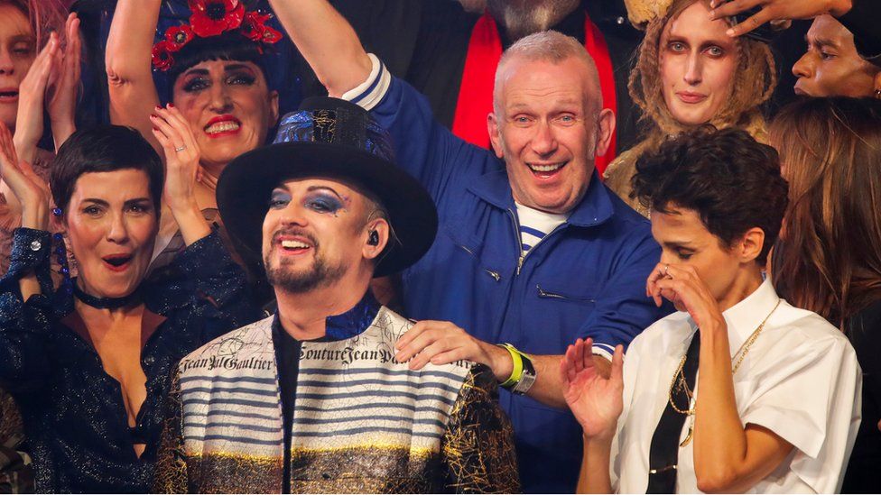 Jean Paul Gaultier places an arm on Boy George's shoulder at the end of his fashion show