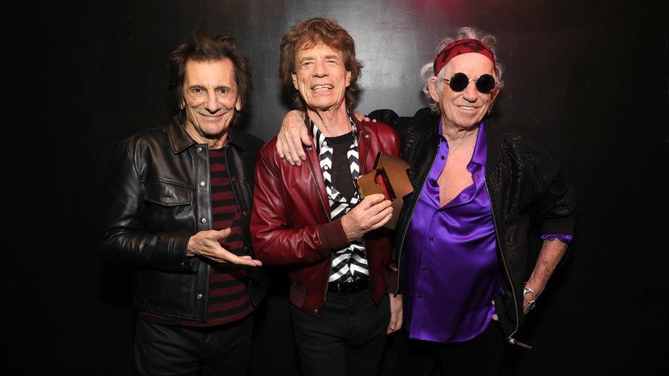 Rolling Stones with a chart trophy