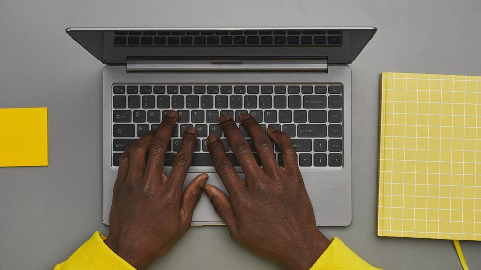 Person with hands on a keyboard