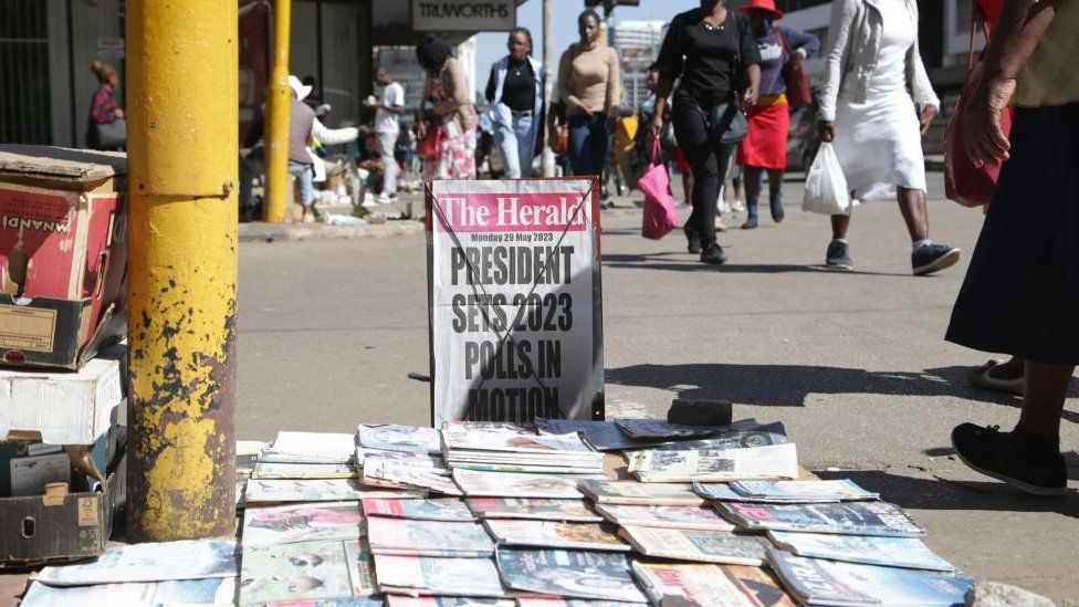 Un cartel de periódico sobre las elecciones de 2023 se muestra en una concurrida calle de Harare, Zimbabue - 29 de mayo de 2023