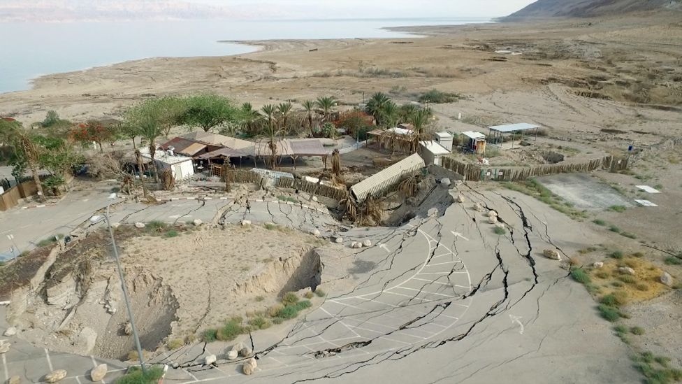 A series of structures that have been swallowed by a sinkhole on the Mineral Beach