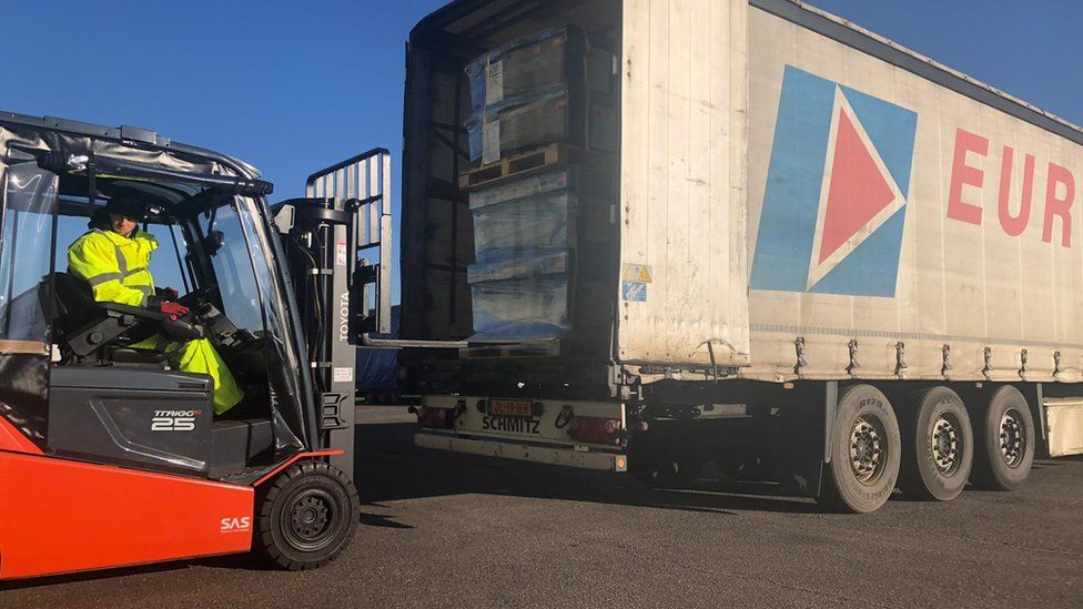 Boxes of supplies being loaded into a truck