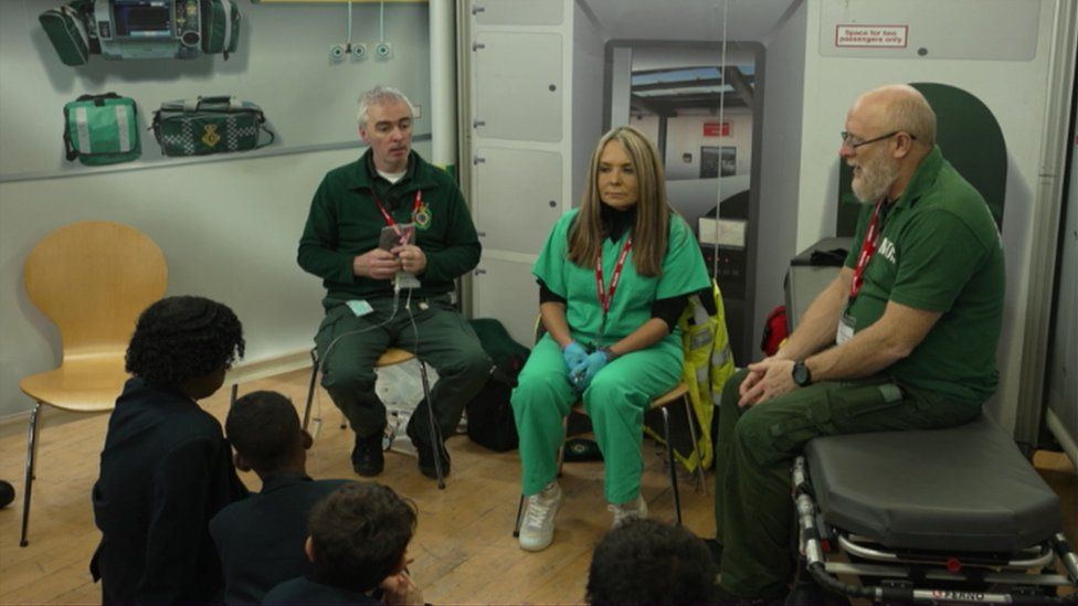 Paramedic Michael Laverty (left) with colleagues speaks to pupils during the project