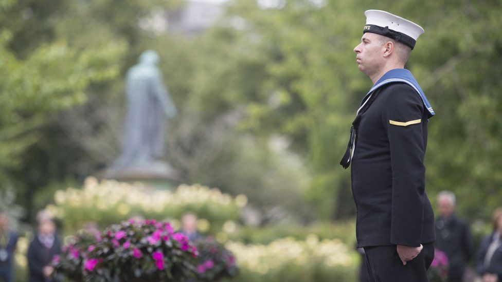 A sailor stands to mark the silence in memory of the Somme