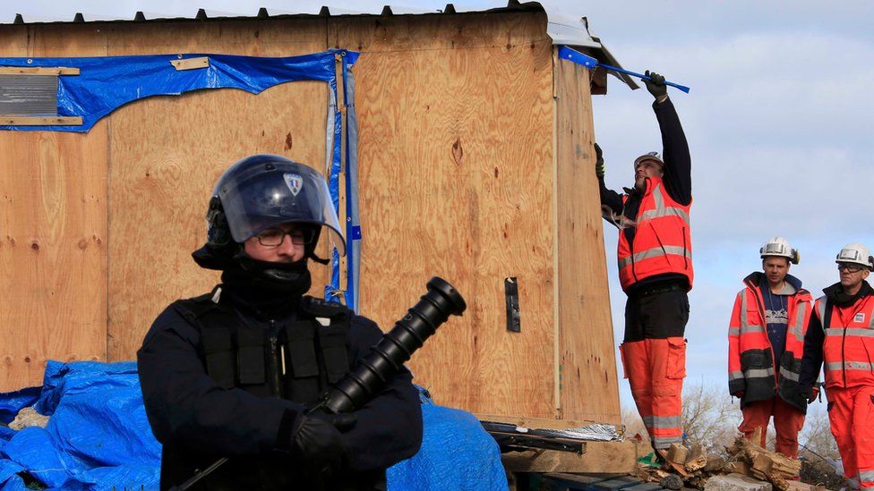Workmen destroy a makeshift shelter during the partial dismantlement of the camp for migrants called the "jungle", in Calais, northern France, 29 February, 2016.
