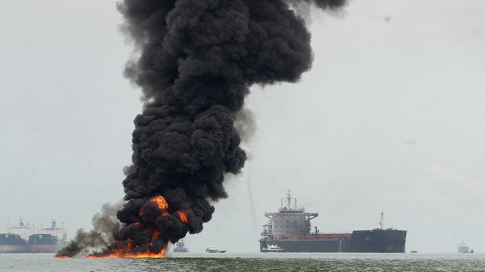 Black smoke billows from as oil burns in the coastal waters of Balikpapan, Indonesia, 31 March 2018