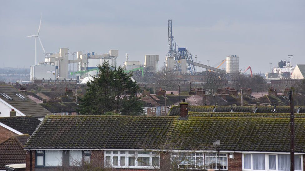 Tilbury Cement and Ash Plant seen above the rooftops of residential homes at Tilbury Docks in Essex on 16 January 2023