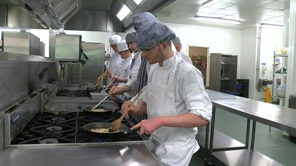Rhys Harris cooking in his chef whites