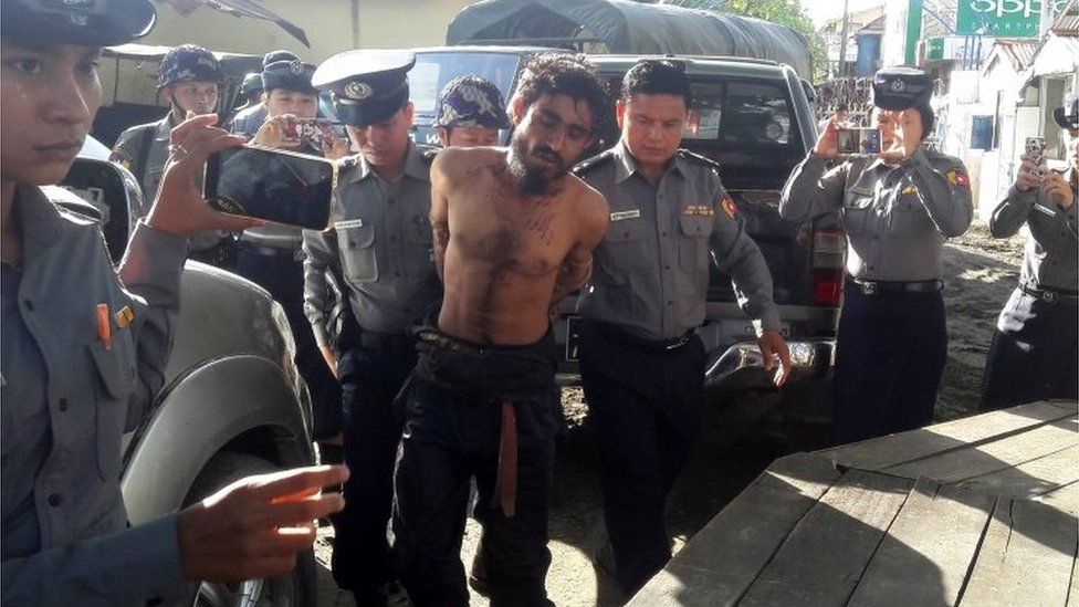 In this photograph taken on October 9, 2016, a man suspected of being one of the attackers in recent border raids is taken to a police station in Sittwe, capital of the Rakhine state.