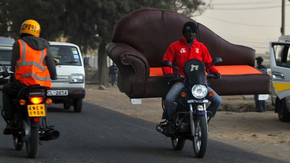 A motorbike taxi, commonly referred to as boda-boda, ferries a couch during evening traffic in the Kenyan capital Nairobi September 26, 2018.