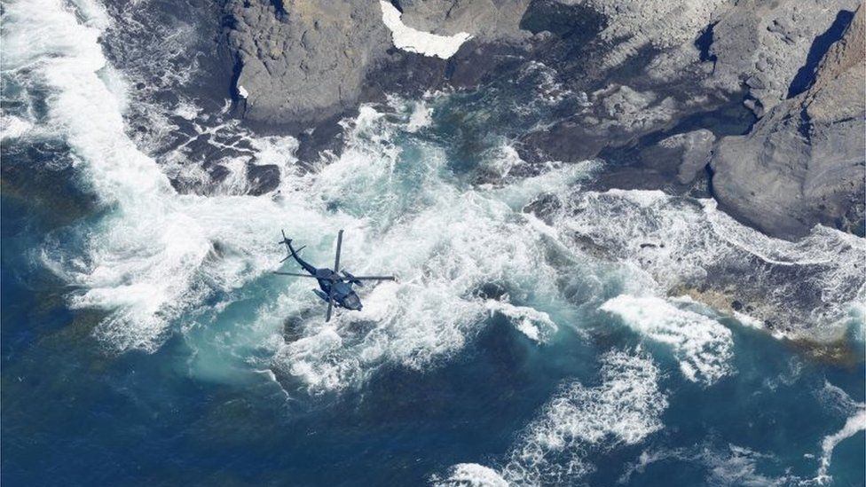A helicopter searches for missing people onboard the tour boat "Kazu 1" that went missing off the Shiretoko Peninsula in Shari, Hokkaido Prefecture, Japan in this photo taken by Kyodo on April 25, 2022.