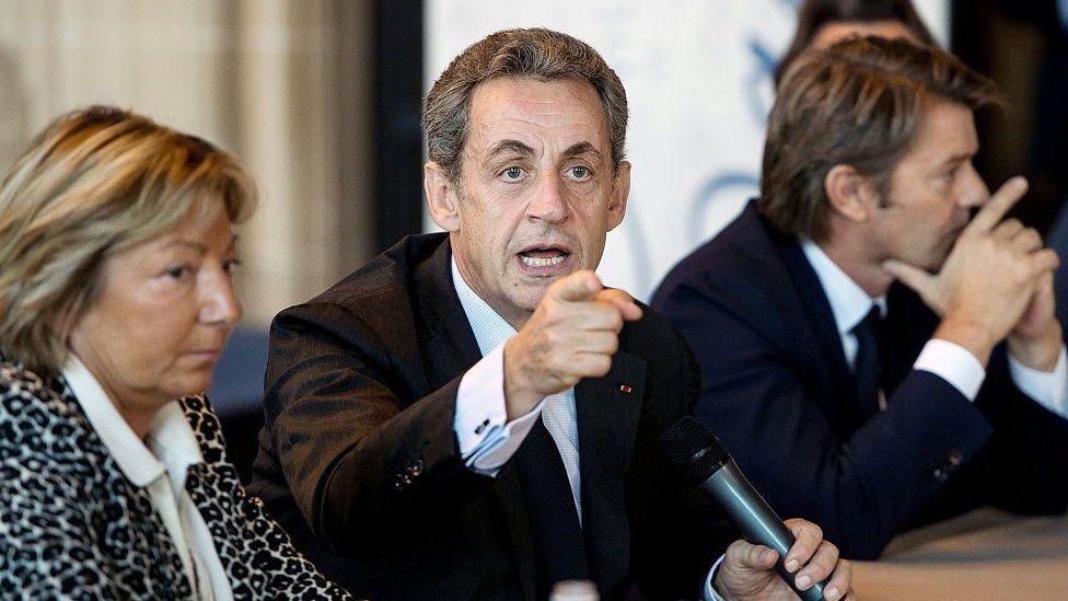 Former French president and hopeful candidate for the right-wing Les Republicains (LR) party in 2017 presidential election Nicolas Sarkozy (C) flanked by Calais Mayor Natacha Bouchart (L) and LR party member Francois Baroin, gestures as he speaks in Calais' town hall, northern France, on 21 September 2016