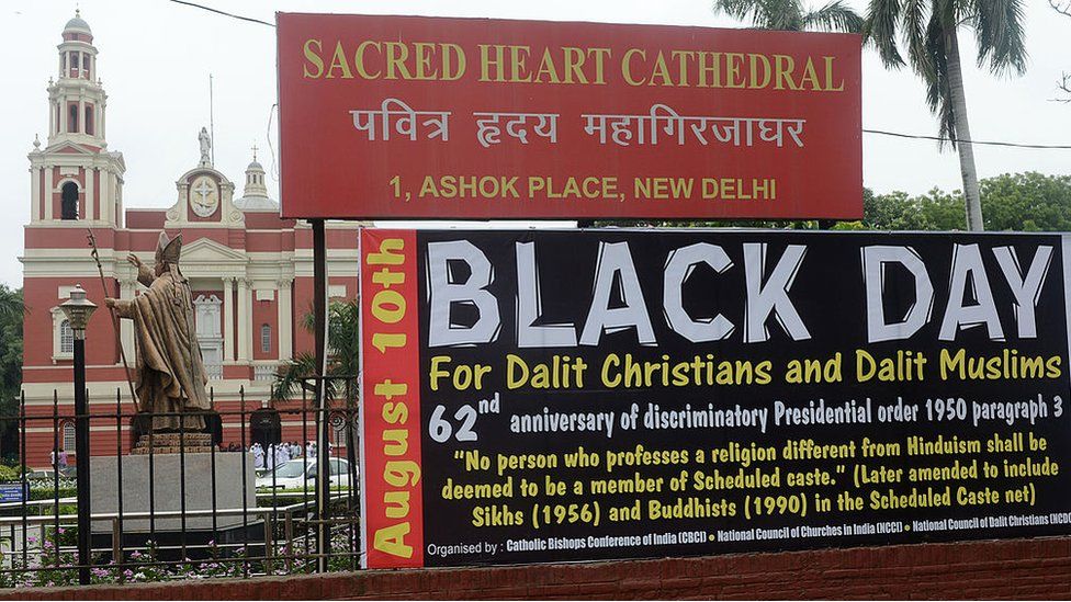 billboard shows August 10 as a Black Day in front of Sacred Heart Cathedral church in New Delhi on August 10, 2012. The National United Christian Forum demanded that the United Progressive Alliance (UPA) government grant equal rights and reservation for the Dalit caste Christians and Muslims