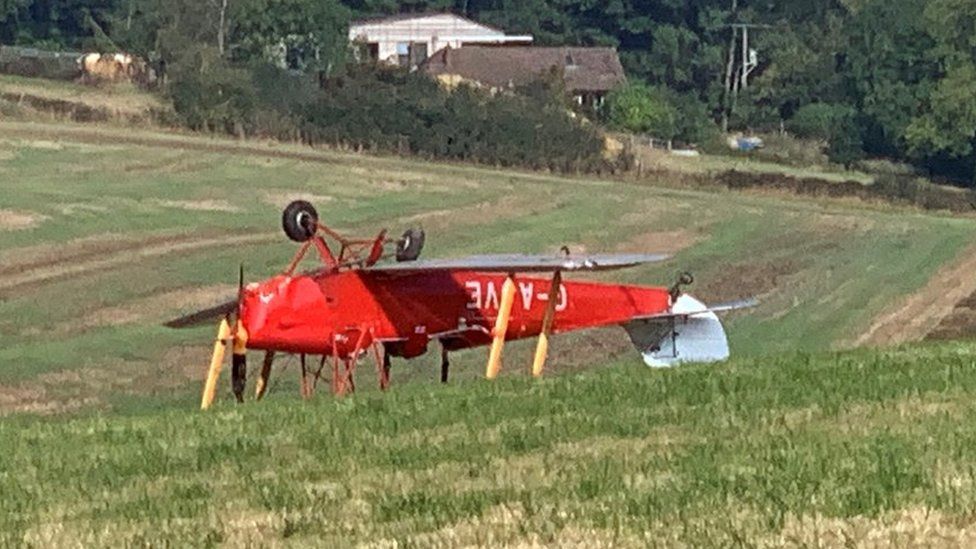 G-AJVE plane lying upside down in a field