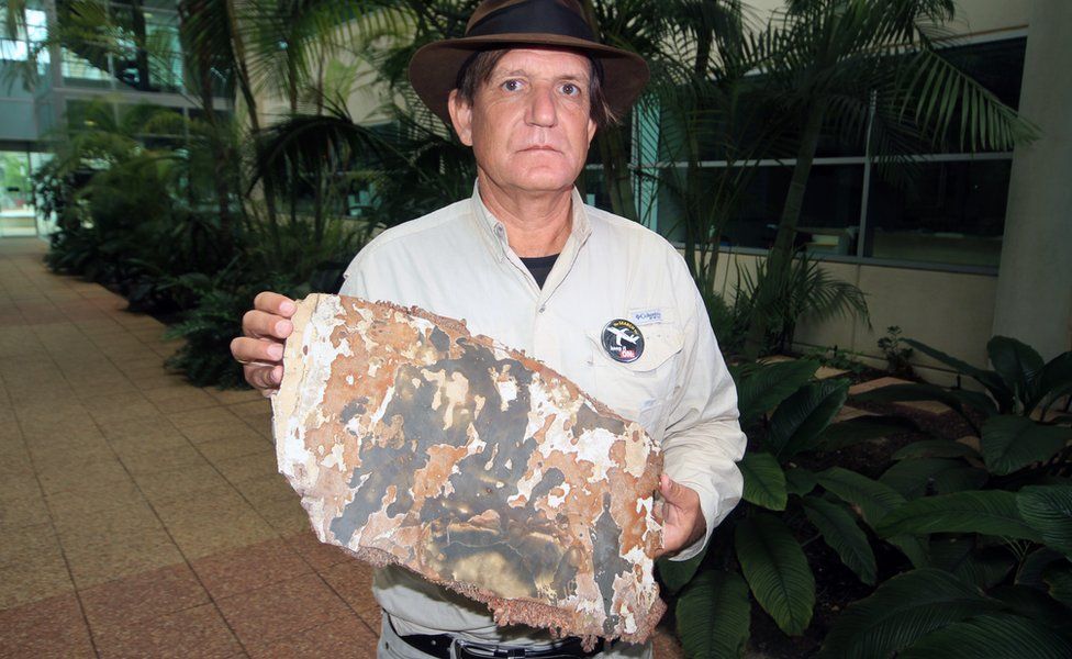 Blaine Gibson, who has been searching for parts of the missing flight MH370, shows piece of debris that has been found