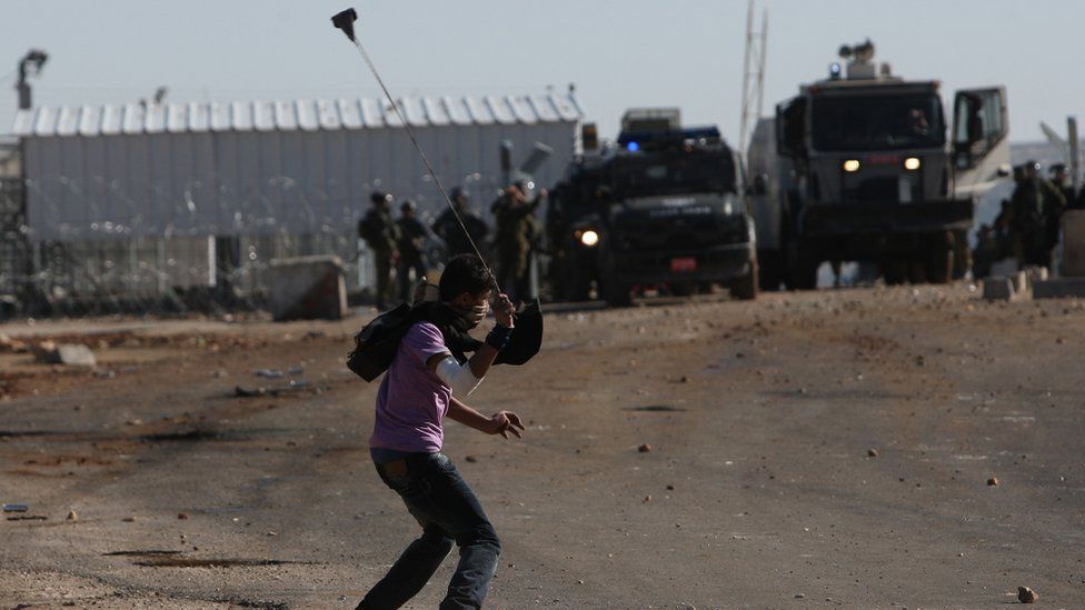 Palestinian swings sling towards Israeli troops near Ramallah (file photo)