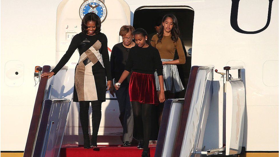 Michelle Obama with her mother and daughters walking out of Air Force One