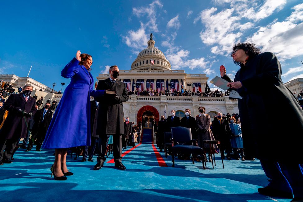 Kamala Harris (L), standing next to her husband Douglas Emhoff,, is sworn in as US vice-president by Justice Sonia Sotomayor (R)