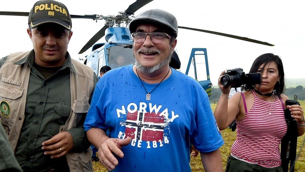 FARC rebel leader Rodrigo Londono Echeverri (C), better known by his nom de guerre "Timochenko", alights from the helicopter upon his arrival at the Transitional Standardization Zone Mariana Paez, Buena Vista, Mesetas municipality, Colombia on June 26, 2017, for the final act of abandonment of arms and its end as an armed group.