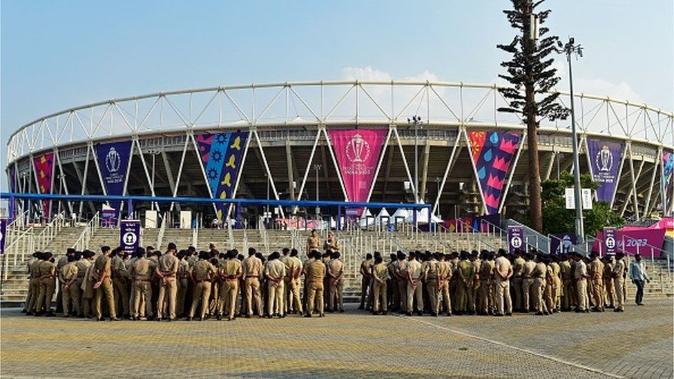 Police personnel gather outside the stadium for a briefing ahead of the 2023 ICC Men's Cricket World Cup one-day international (ODI) match between India and Pakistan at the Narendra Modi Stadium in Ahmedabad October 12, 2023