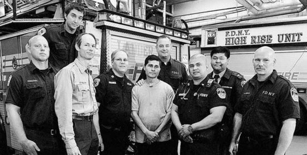 Alcides Moreno (centre) with the FDNY members who rescued him