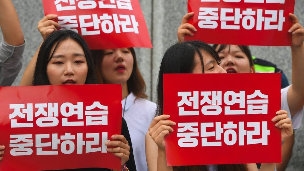 South Korean protestors hold placards that read "stop war exercise" during a rally denouncing the annual Ulchi Freedom Guardian (UFG) joint South Korea-US military exercise, near the US embassy in Seoul on 21 August 2017
