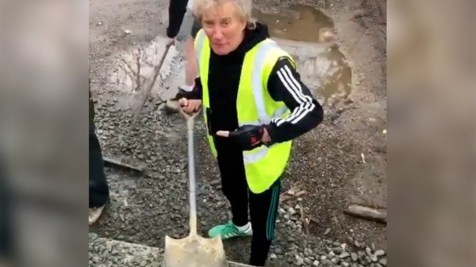 Sir Rod Stewart fixing potholes.