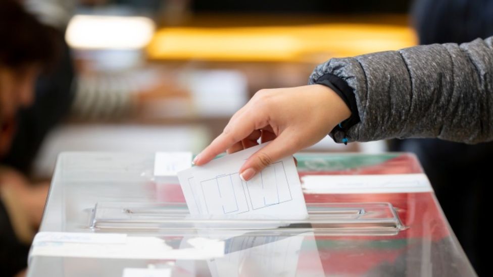 A stock image of someone voting
