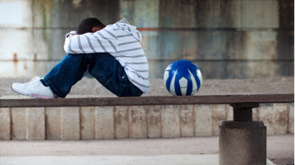 sad boy with ball