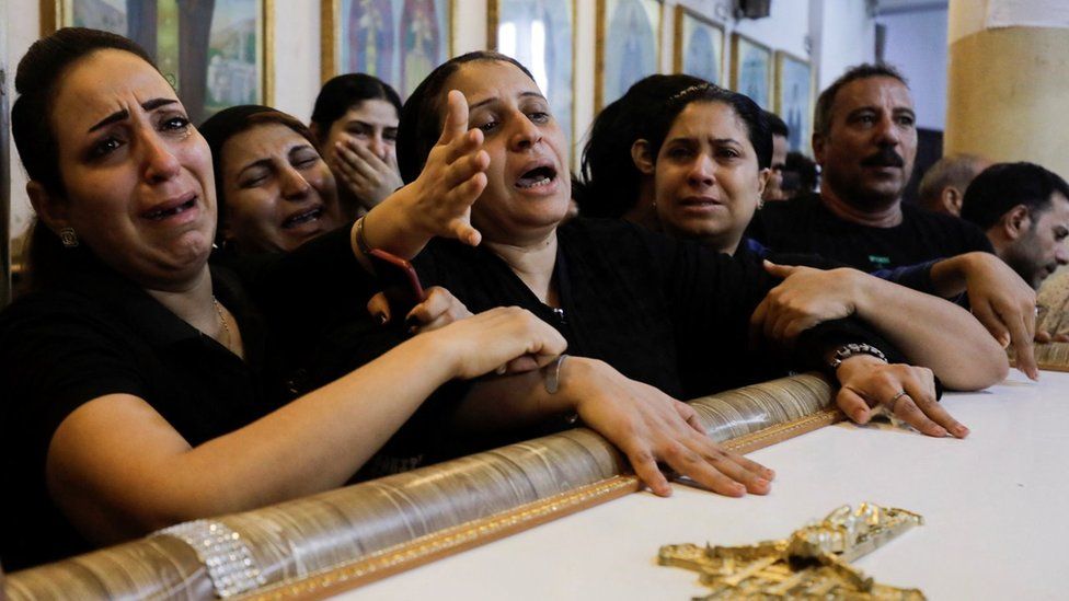 The mother (centre) of three children killed in a fire at a Coptic Church in Giza mourns during a funeral service at the Church of the Blessed Virgin Mary in Giza, Egypt (14 August 2022)