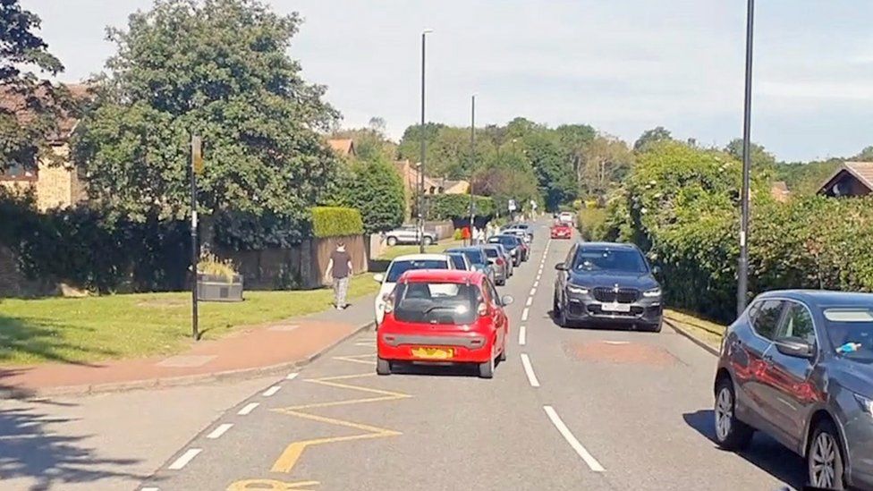 Cars blocking yellow school road markings