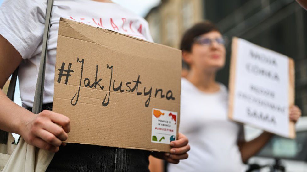 People hold banners during a solidarity protest with Justyna Wydrzynska, a pro abortion activist who faces criminal charges in Krakow, Poland on July 13, 2022