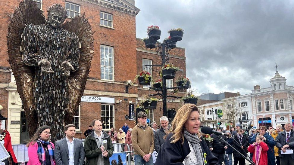 Image of Emma Webber giving a speech in front of the Knife Angel