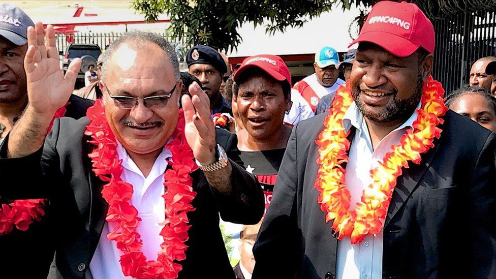 In this handout photo taken on July 16, 2017 shows then Papua New Guinea prime minister Peter O"Neill (L) and then finance minister James Marape (R)