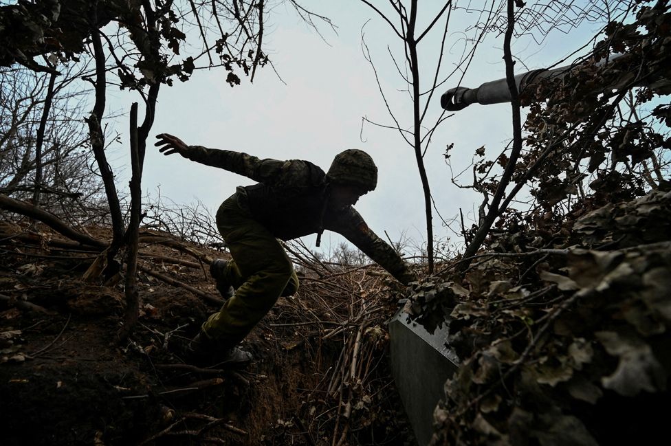 Ukrainian serviceman jumps on a 2S1 Gvozdika self-propelled howitzer at a position on a front line, amid Russia's attack on Ukraine, in Zaporizhzhia region, Ukraine November 15, 2023.