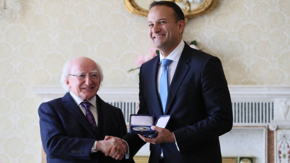 Michael D Higgins presents Leo Varadkar with the seals of office