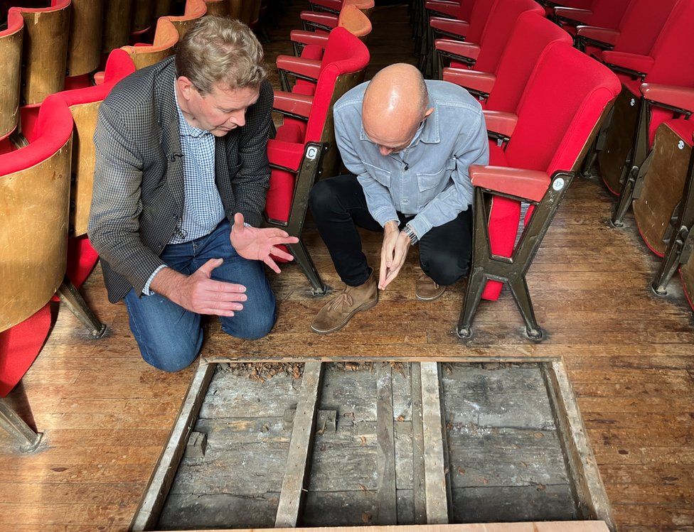 Dr Jonathan Clark showing Colin Paterson the original floorboards