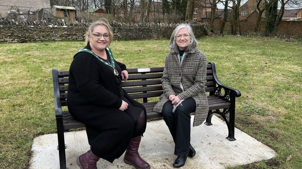 Mendip's outgoing chair Helen Sprawson-White and councillor Heather Shearer on one of the new benches in Shepton Mallet's Collett Park