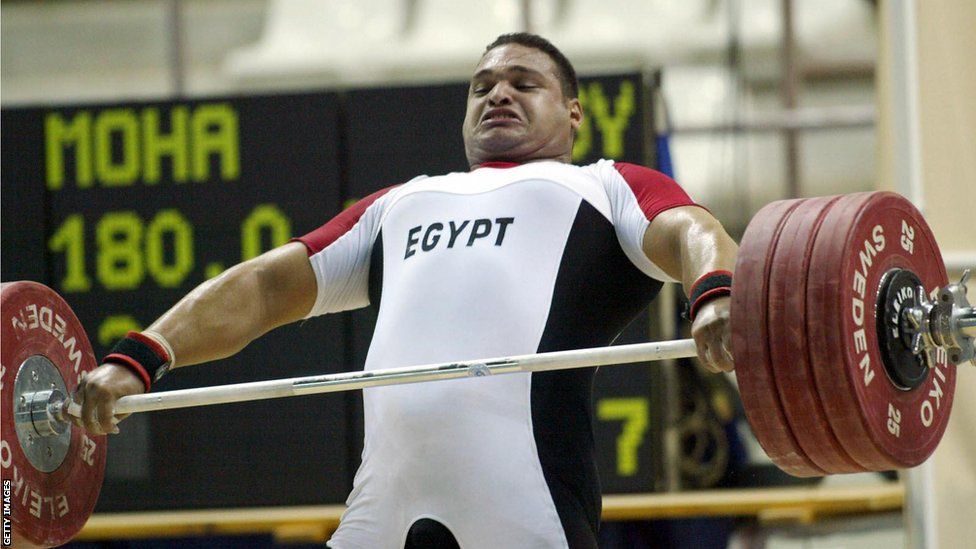 Egyptian weightlifter Mohammed Ehsan grimaces mid-lift in the clean and jerk at the All-African Games in Abuja in 2003