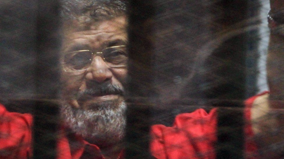 Ousted Egyptian President Mohamed Morsi looks on during a trial session on charges of espionage in Cairo,