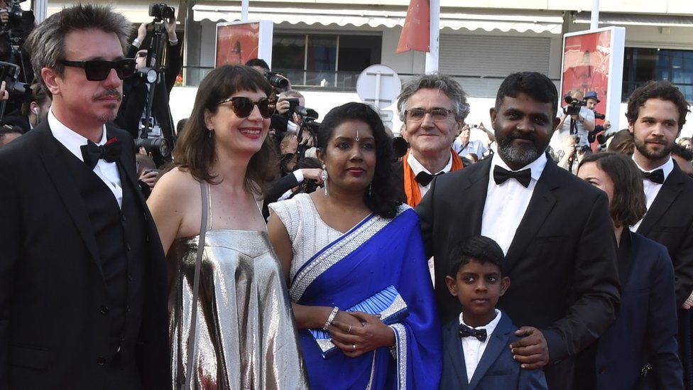 Jude Ratnam with his family and the Demons in Paradise production team at the Cannes film festival