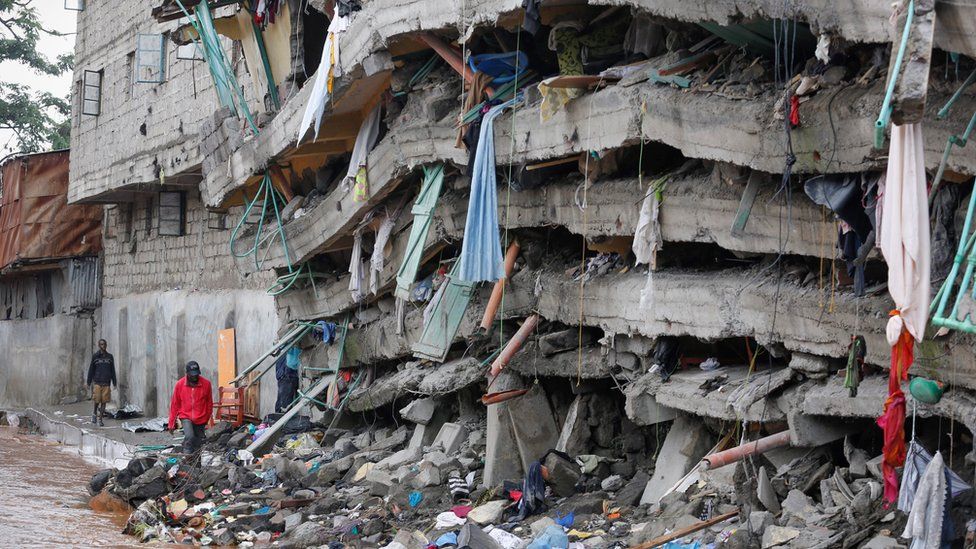 Local residents walk near collapsed building - 1 May