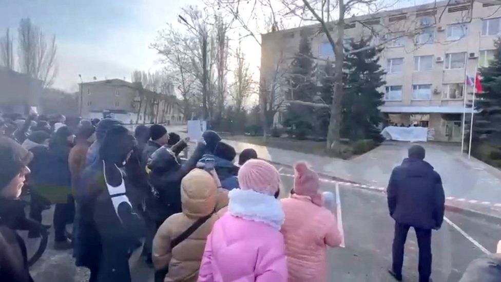 People protest the abduction of Melitopol mayor Ivan Federov outside the regional administration building, after he was reportedly taken away by Russian forces, during their ongoing invasion