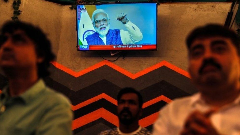 People watch a live address by Indian Prime Minister Narendra Modi after the government scrap Article 370, at a restaurant in Mumbai, India, 08 August 2019.