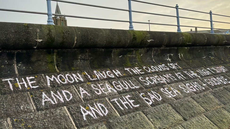 Lemn Sissay's poem about the tragedy has been chalked on to a sea wall