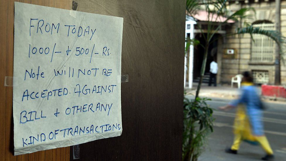 A notice regarding discontinued 500 and 1,000 rupee notes is posted at the entrance of a restaurant in Mumbai